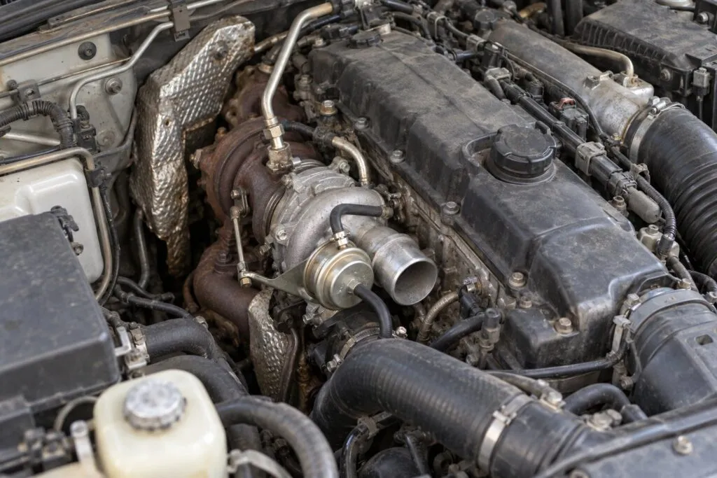Mitsubishi 4M41 3.2L Turbocharger Guide: Pajero, Triton & L200 Replacement 10 Pajero 4M41 engine bay with its installed variable-geometry turbo and pneumatic actuator exposed for inspection